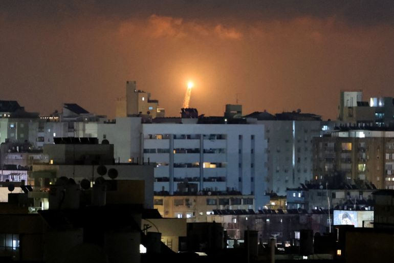 Rocket trails are seen in the sky above the Israeli coastal city of Netanya amid a fresh barrage of Iranian missile attacks on June 17, 2025.