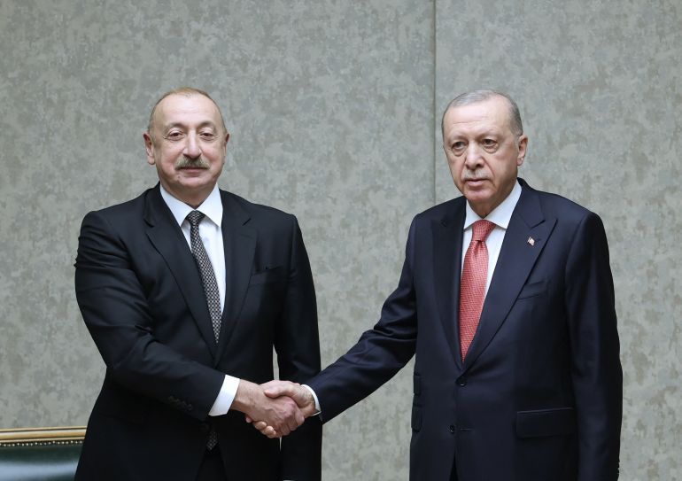 This handout photograph taken and released by the Turkish Presidency Press Office on June 19, 2025, shows Turkey's President Recep Tayyip Erdogan (R) shaking hands with Azerbaijan's President Ilham Aliyev (L) during their meeting in Kahramanmaras. (Photo by Handout / Turkish Presidency Press Office / AFP) / RESTRICTED TO EDITORIAL USE - MANDATORY CREDIT 