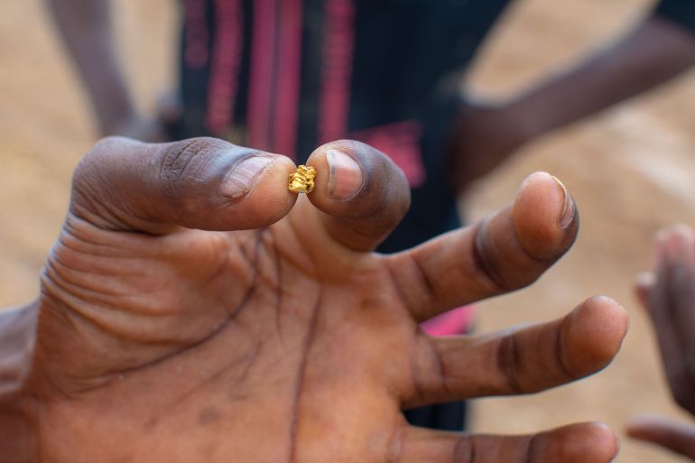 KUNSU, GHANA – May 22, 2022: Ghanaian Illegal miner finds a small nugget of gold. Ghana gold nugget.