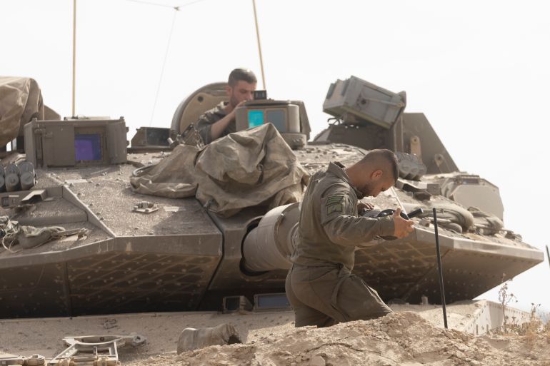 SOUTHERN ISRAEL, ISRAEL - MAY 19: Israeli soldiers work on a tank cannon near the border with the Gaza Strip on May 19, 2025 in Southern Israel, Israel. The Israeli military has said its expanding ground operations in Gaza as part of what they're calling 'Operation Gideon's Chariots,' aimed at securing the release of hostages still held in Gaza, as well as