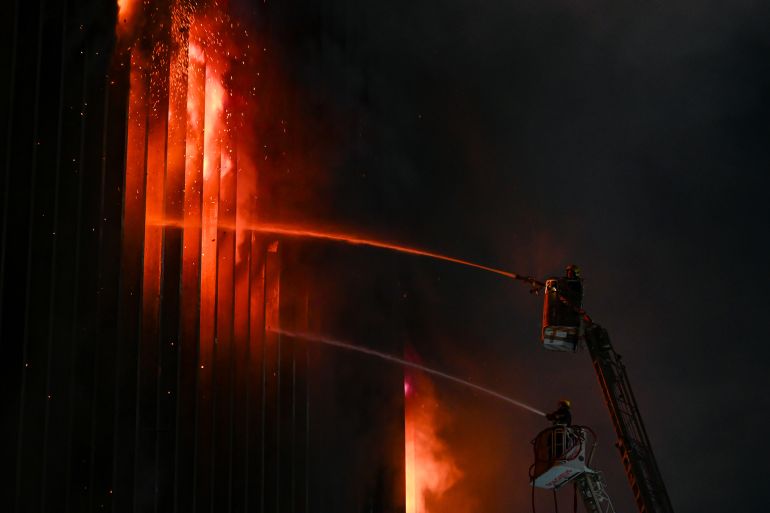 CAIRO, EGYPT - JULY 7: Firefighters douses the flames after a fire broke out in the Telephones landline exchanging station and Ministry of Communications building in the heart of Cairo on July 7, 2025 in Cairo, Egypt. A fire broke out in a telecoms building in the Ramses district of Cairo on Monday, causing communications network disruption, according to local media. (Photo by Sayed Hassan/Getty Images)