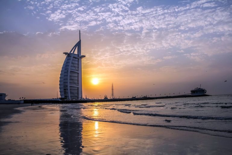 Dubai, United Arab Emirates -01/25/2018 - Evening view of Burj Al Arab, Seven Star Hotel, A view from Jumeirah Beach, Arabian Sea, Residential and Business Skyscrapers, Dubai, UAE