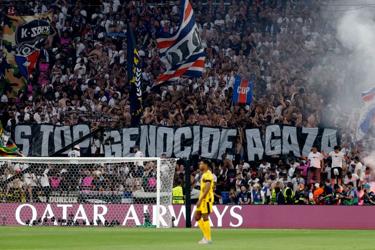 TOPSHOT - Fans hold a giant banner reading