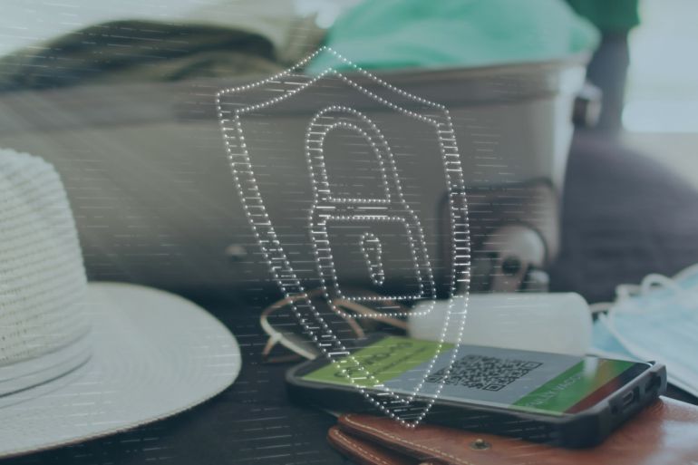 Image of digital padlock and shield over smartphone with qr code, luggage, hat and mask on bed. Digital composite, multiple exposure, protection, security code and travel concept.