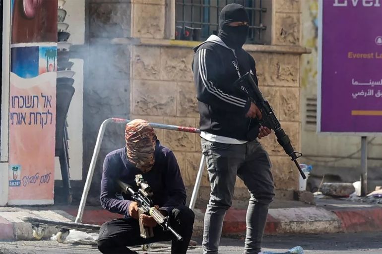 Palestinian armed militants take up position during a confrontation with Israeli army in the occupied West Bank city of Jenin on July 3, 2023. The Israeli army said it had launched drone strikes in Jenin as part of an