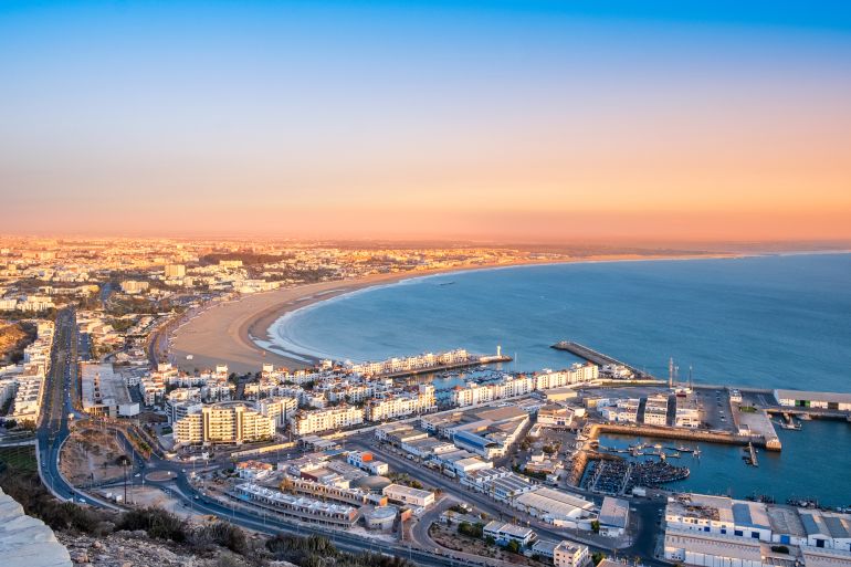 Agadir, Morocco at sunset. Panoramic view of Agadir city and bay in southern Morocco with Marina, beach and ocean from Oufla or Casbah fortress. Moroccan seaside resort on Atlantic coast in Africa.