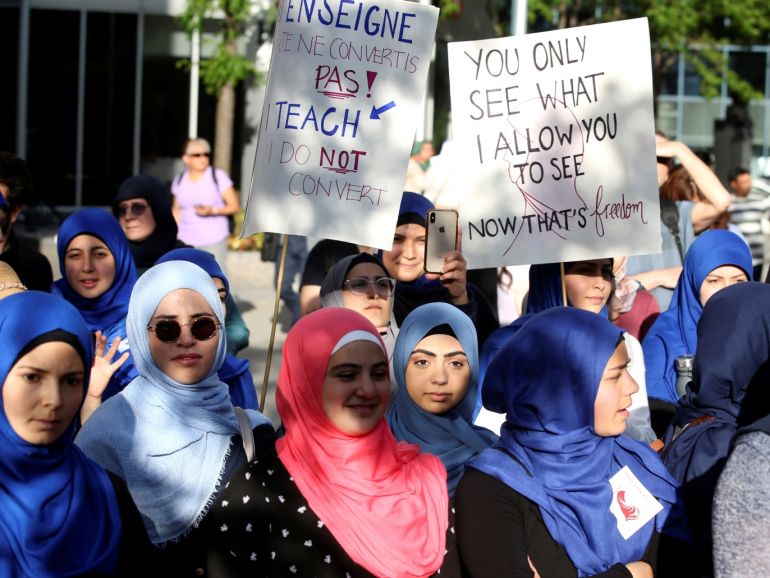 A group of women protest Quebec's new Bill 21, which will ban teachers, police, government lawyers and others in positions of authority from wearing religious symbols such as Muslim head coverings and Sikh turbans, in Montreal, Quebec, Canada, June 17, 2019. REUTERS/Christinne Muschi