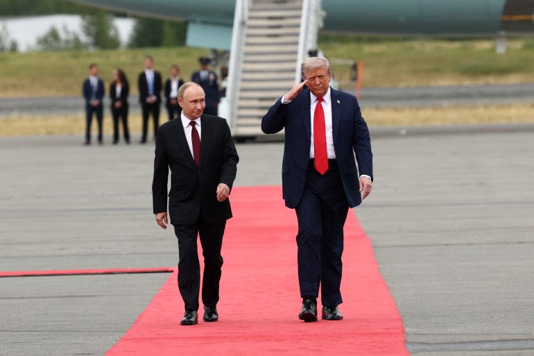 U.S. President Donald Trump walks with Russian President Vladimir Putin, as they meet to negotiate for an end to the war in Ukraine, at Joint Base Elmendorf-Richardson in Anchorage, Alaska, U.S., August 15, 2025. REUTERS/Kevin Lamarque