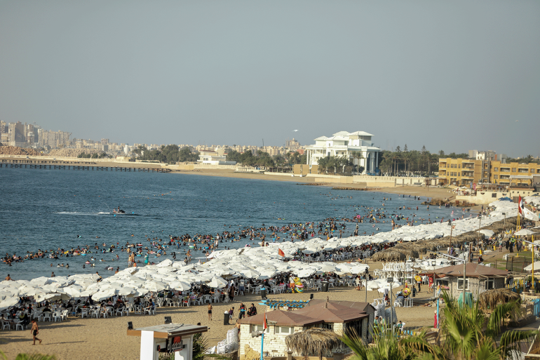 ALEXANDRIA, EGYPT - AUGUST 20: People cool off at the beach as residents and tourists flock to the city’s coasts and parks to escape the heat on August 20, 2025 in Alexandria, Egypt.