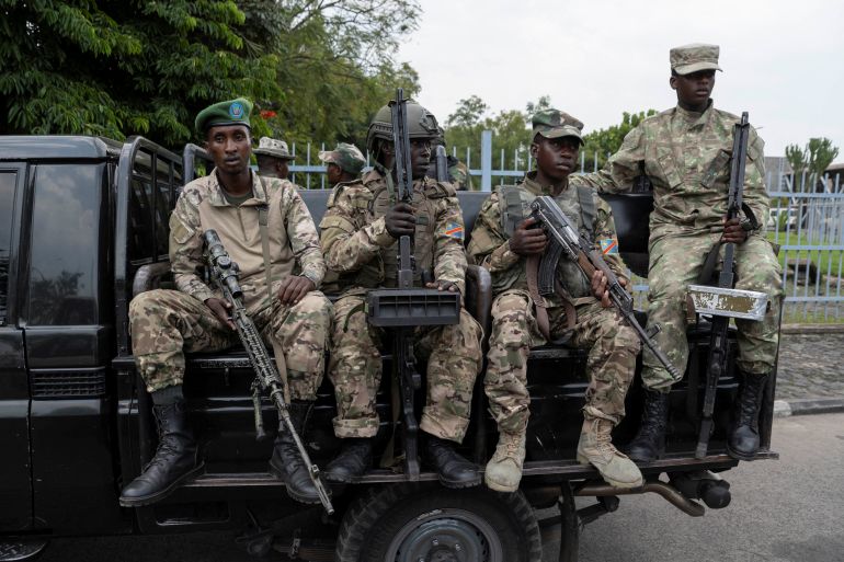 M23 rebels sit on a truck during the escort of captured FDLR members (not pictured) to Rwanda for repatriation, at the Goma-Gisenyi Grande Barrier border crossing, March 1, 2025. REUTERS/Arlette Bashizi